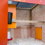 View of the inside of The Basic Coop hen house from the open front door
